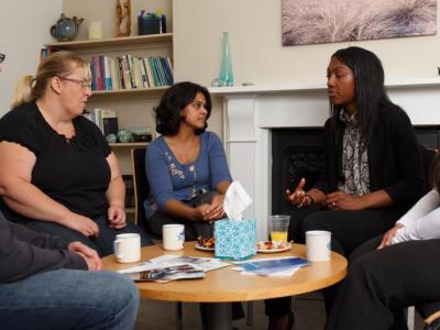A group sitting around a table in a counselling session